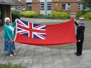 Megan and I with the Red Ensign .  It was officially raised on Saturday morning by a member of our CCTV team.